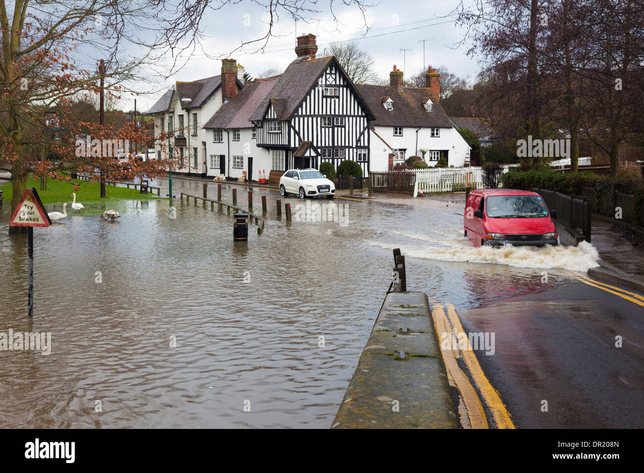 Van drives through flooded river to reach bridge, Eynsford, Kent, UK, winter Stock Photo