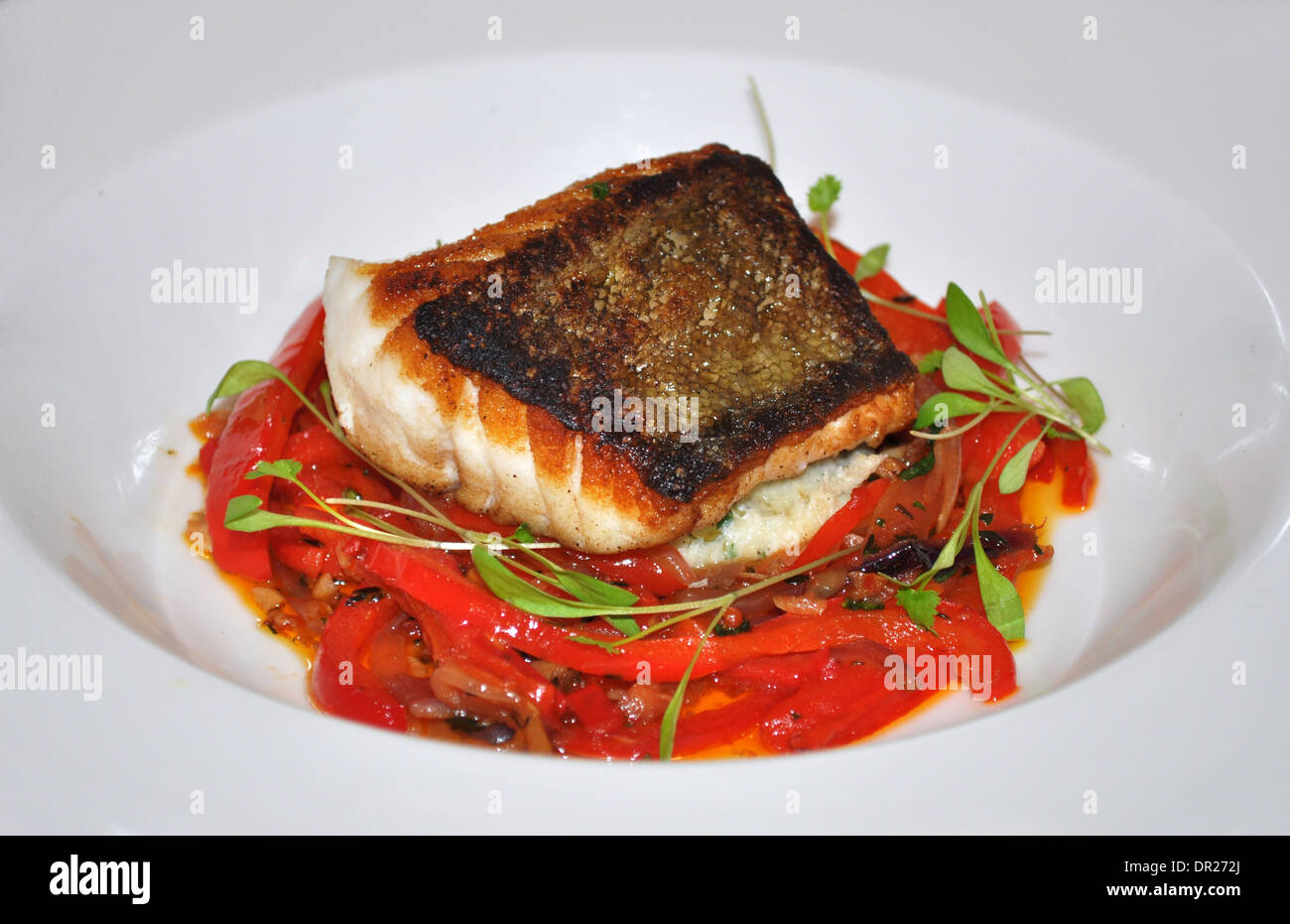 Icelandic cod on mashed potatoes with red peppers at Bistrot Bruno Loubet French restaurant, London Stock Photo