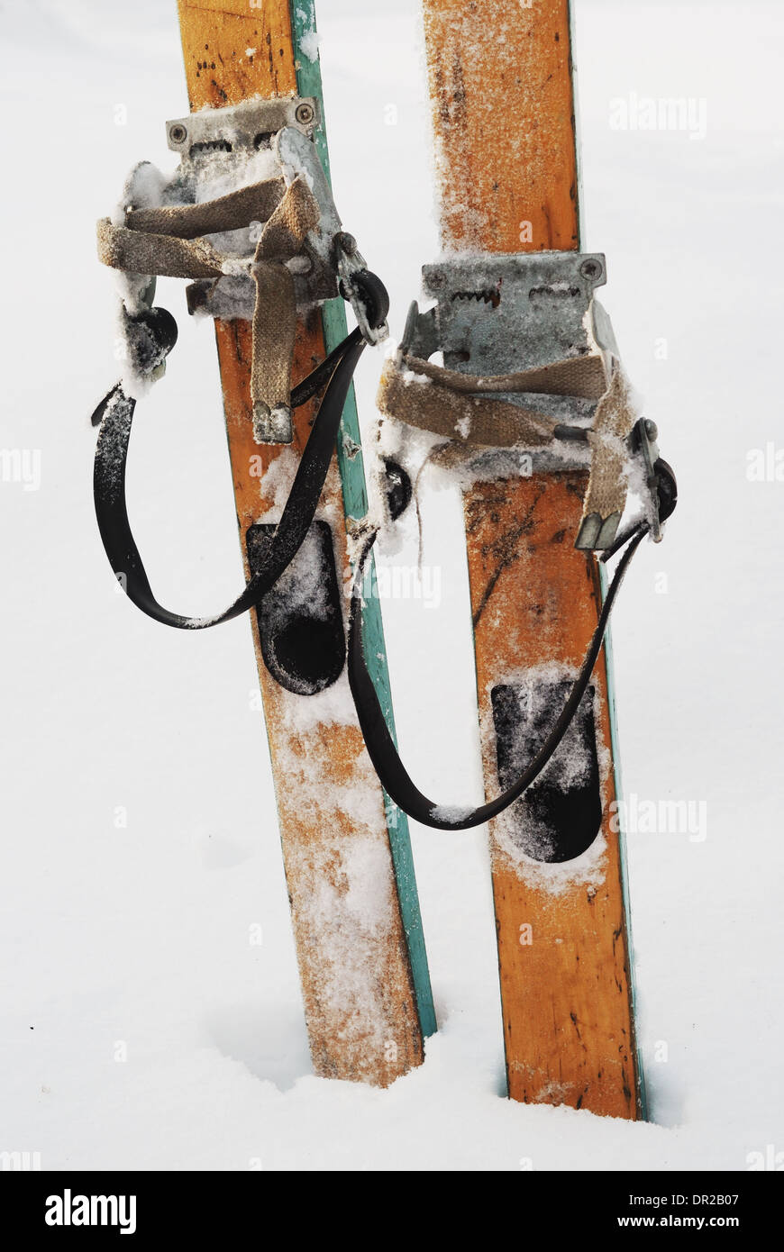 old wooden skis in the snow, vertical Stock Photo