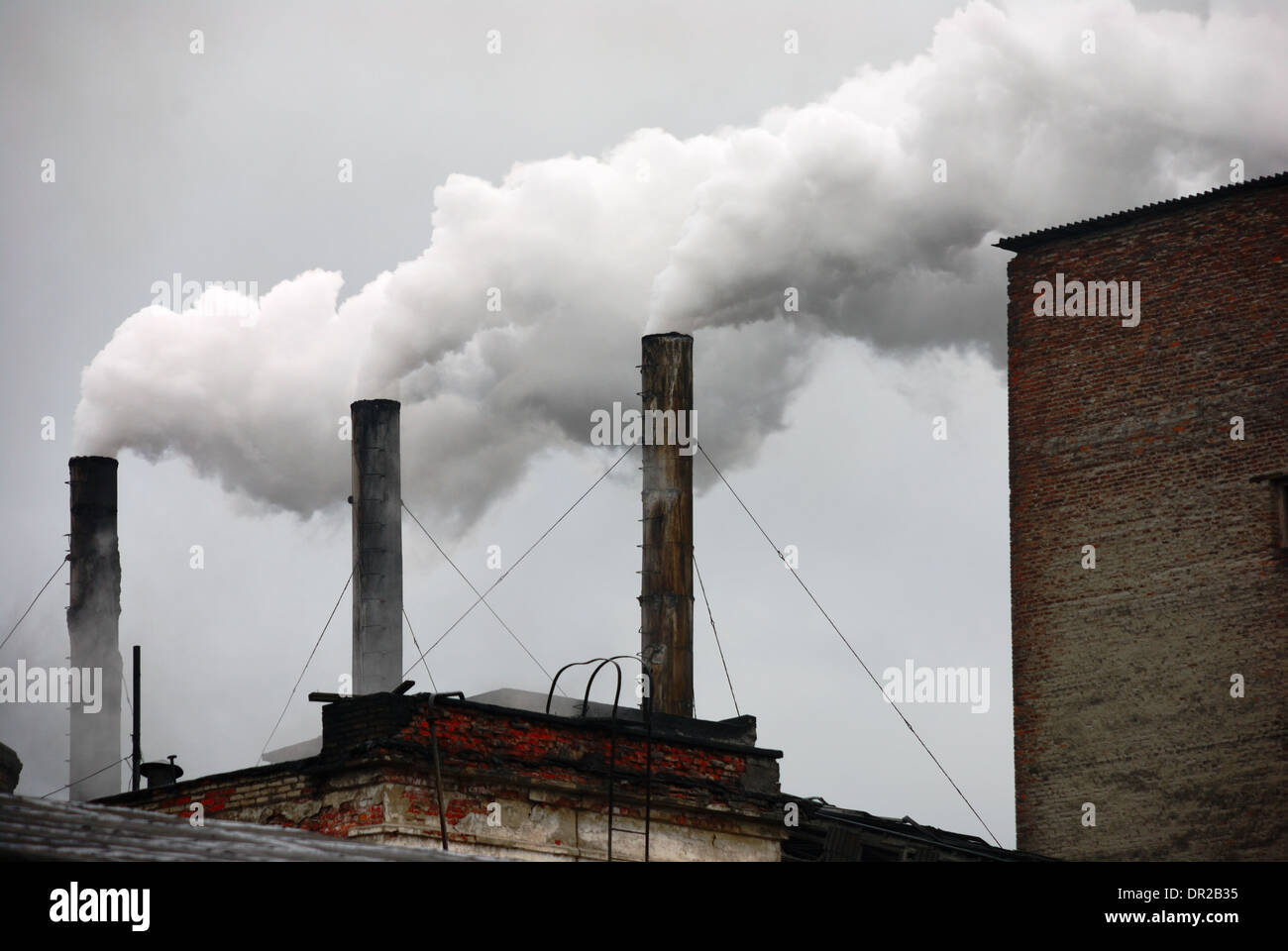 the industrial landscape three smoking factory chimneys Stock Photo