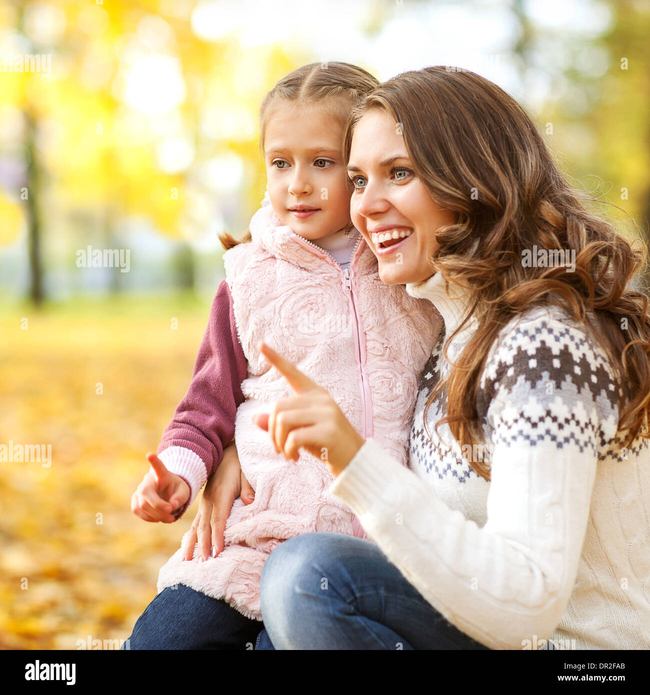 Mother and daughter having fun in the autumn park Stock Photo - Alamy