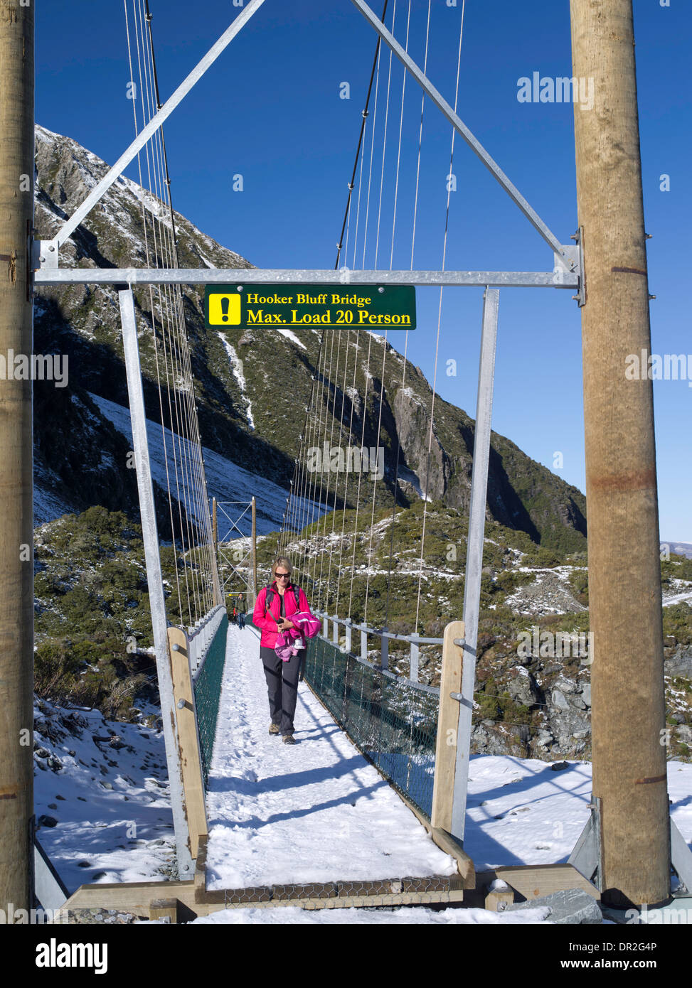 A woman tramps across the Hooker Bluff Suspension Bridge on her way to