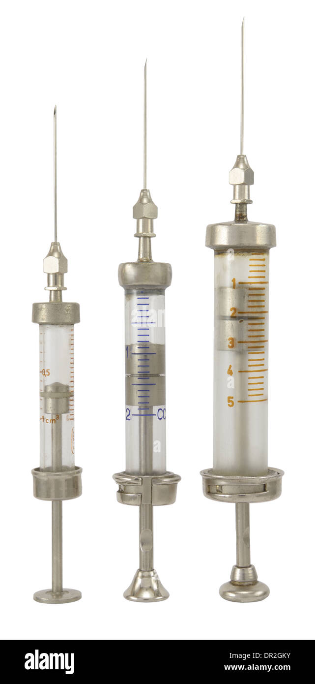 Three old different size syringe with needle isolated on white. Stock Photo