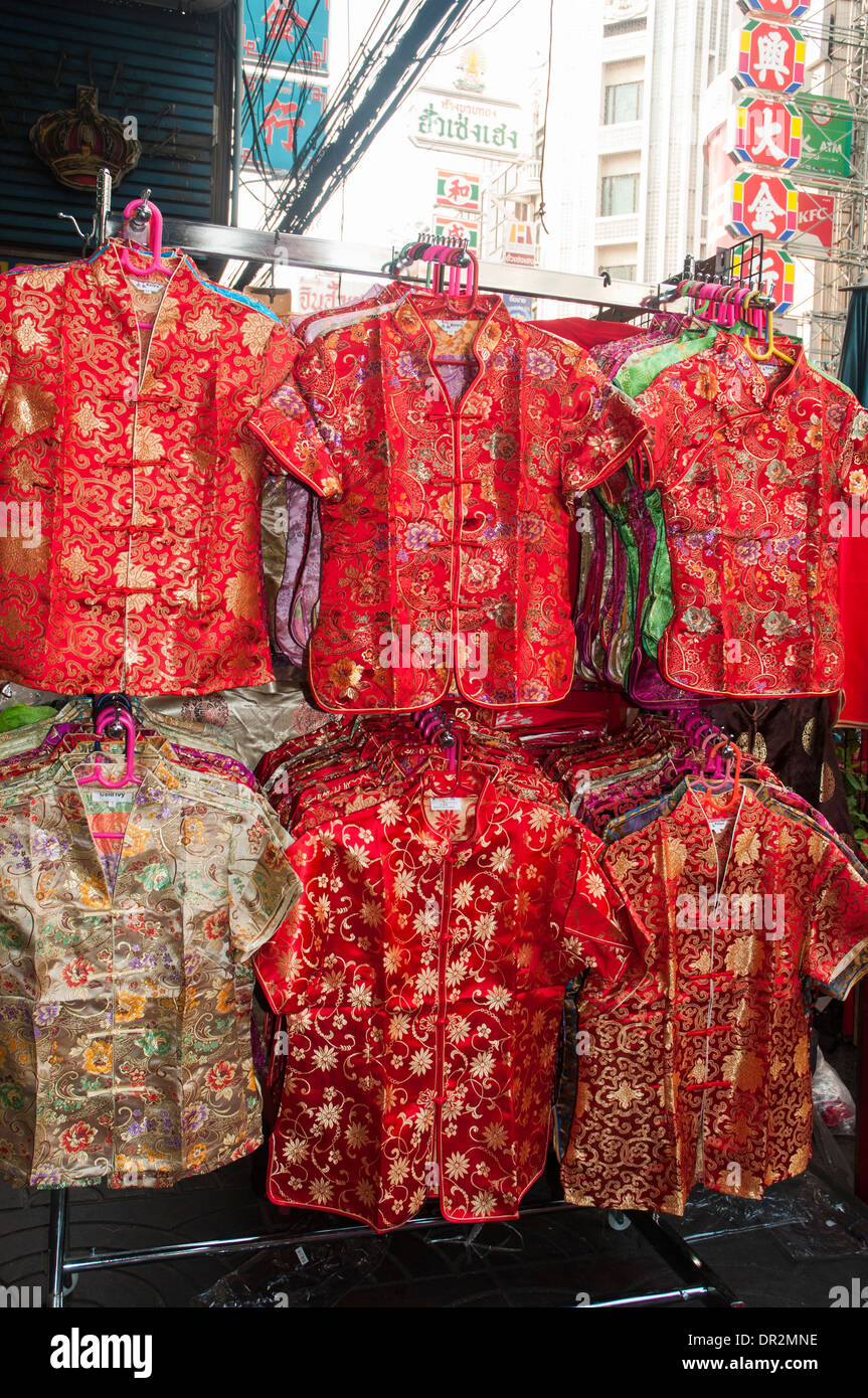 Festive silk blouses in auspicious red and gold, displayed for sale in Bangkok as Chinatown prepares for Chinese New Year Stock Photo