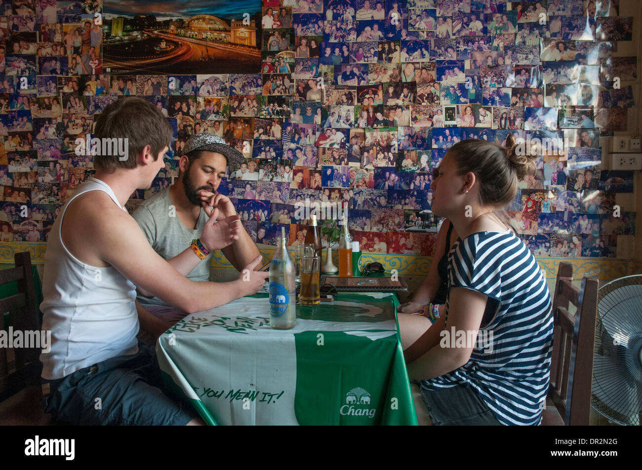 Backpacker tourists patronising a cafe opposite Hualampong Station, Bangkok Stock Photo
