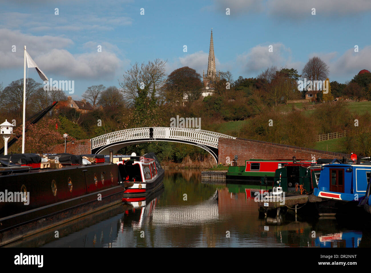 The bridge at the entrance to the marina on the Grand Union Canal and the spire of All Saints’ Church, Braunston, Northants Stock Photo