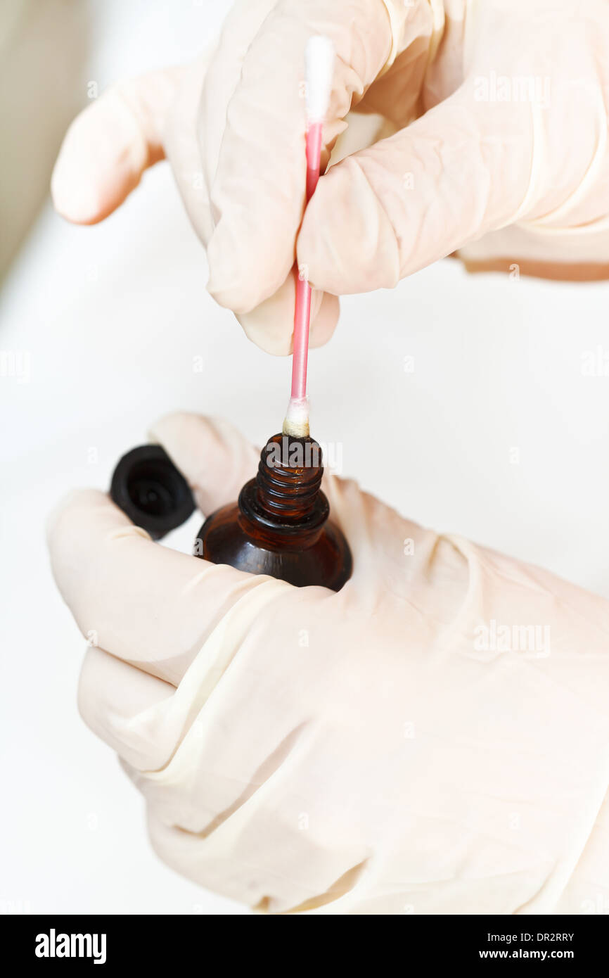 dipping cotton swab into bottle with iodine close up Stock Photo Alamy