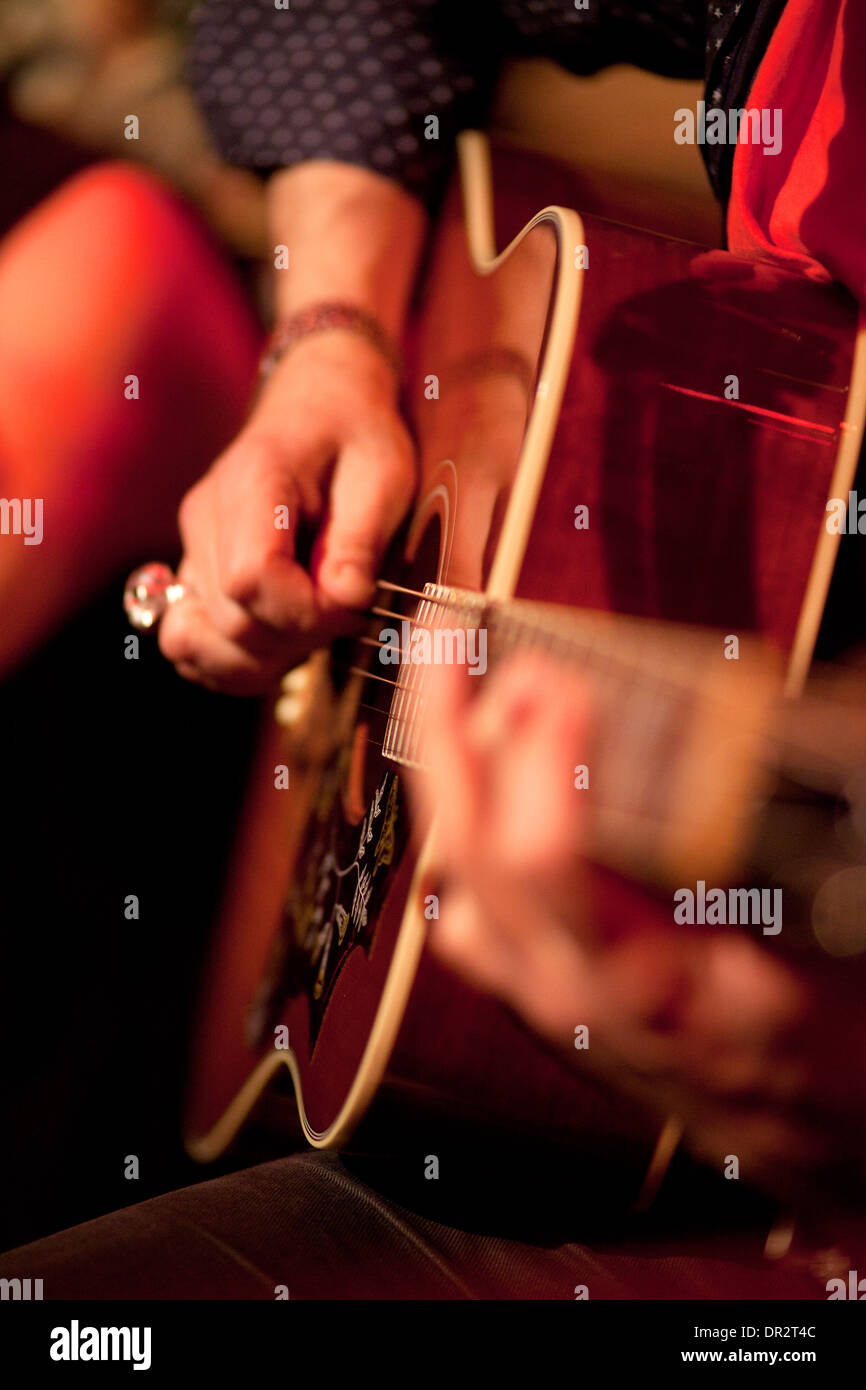 musician playing an acoustic guitar Stock Photo