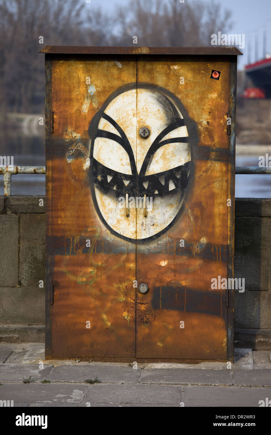 Scary alien face, graffiti on a metal surface in Warsaw, Poland. Stock Photo