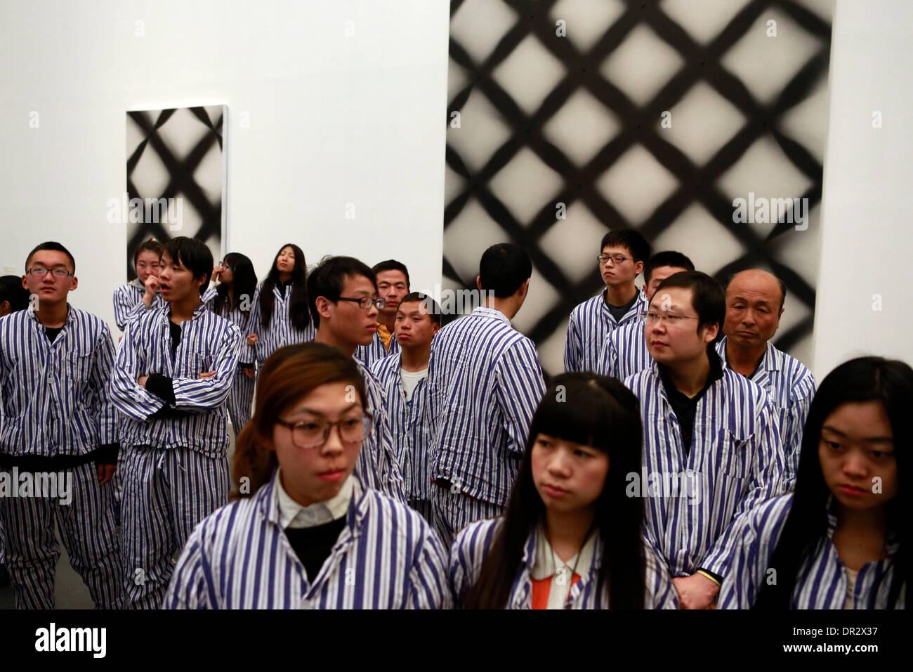 Beijing, China. 18th Jan, 2014. People perform in an installation art creation at the 798 Art Zone in Beijing, capital of China, Jan. 18, 2014. A Xu Zhen's art show was held here on Saturday. Xu Zhen is a Chinese contemporary artist, whose extensive body of work includes photography, installation art, video and performance art. Credit:  Ren Zhenglai/Xinhua/Alamy Live News Stock Photo