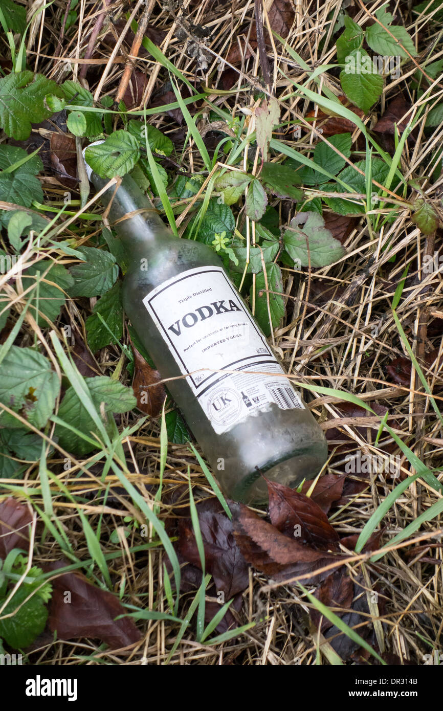 Vodka drinks bottle discarded on verge of country road Stock Photo