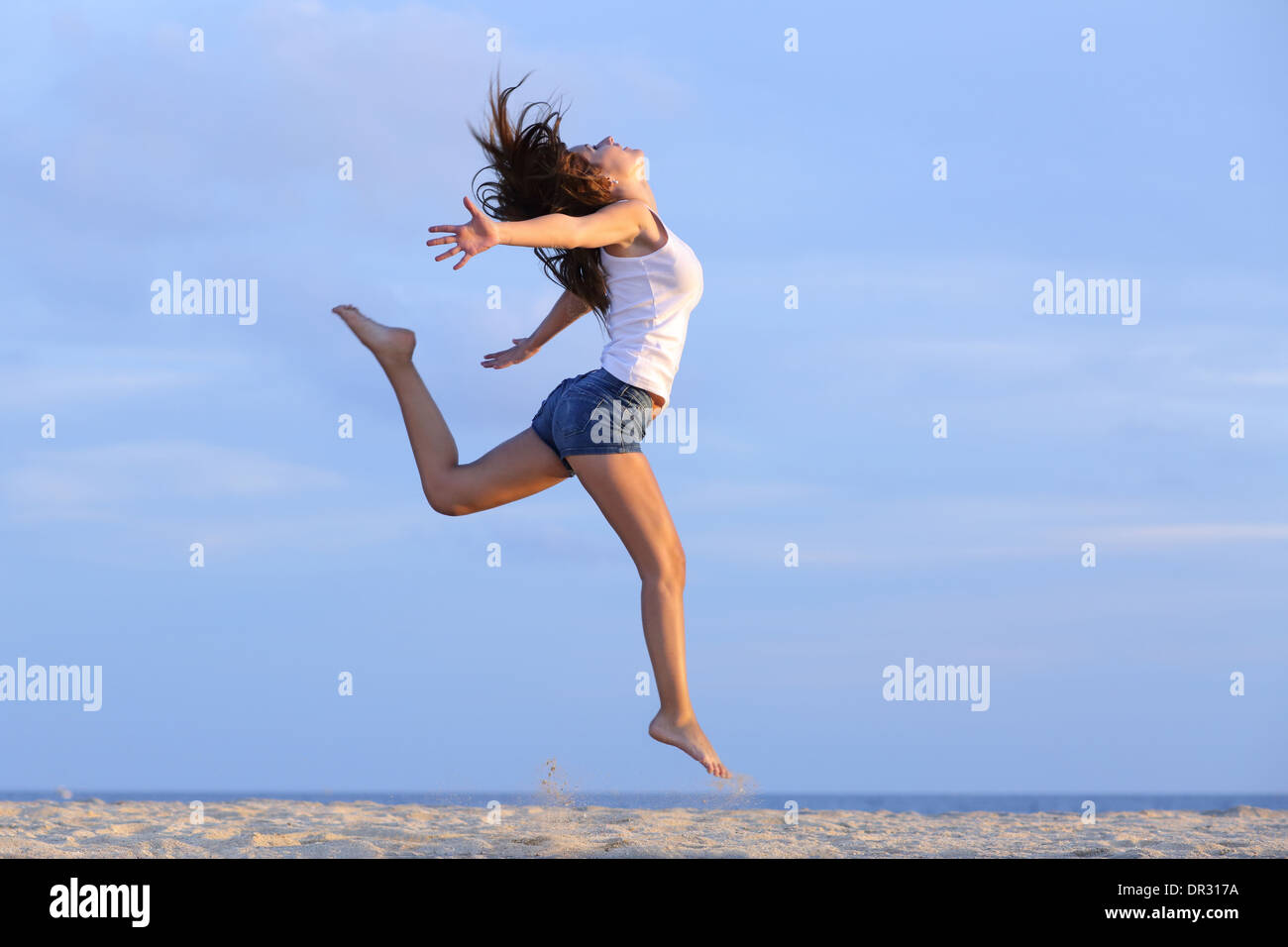 Woman dancing beach jeans hi-res stock photography and images - Alamy