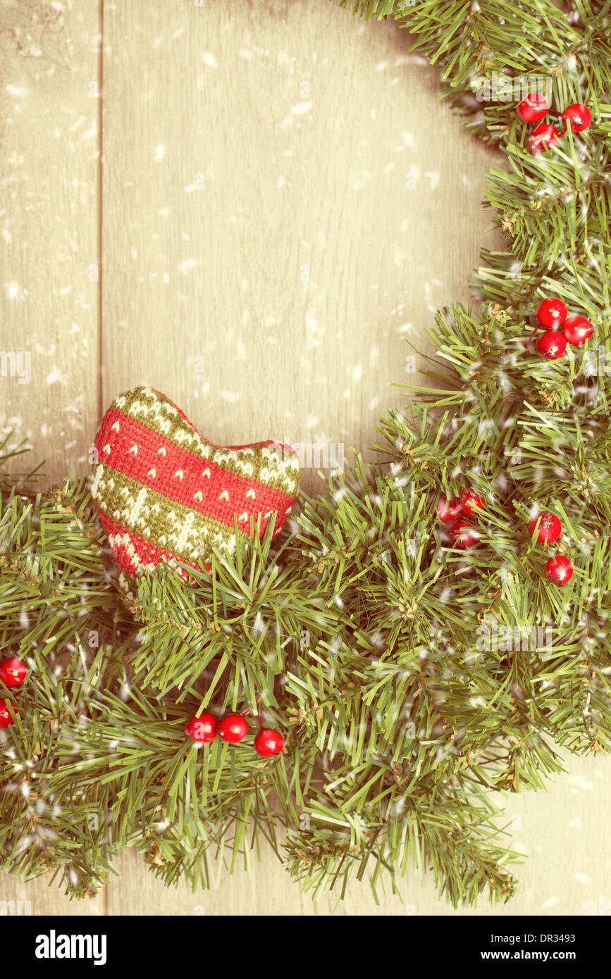 Christmas garland with falling snow - vintage filter tone Stock Photo