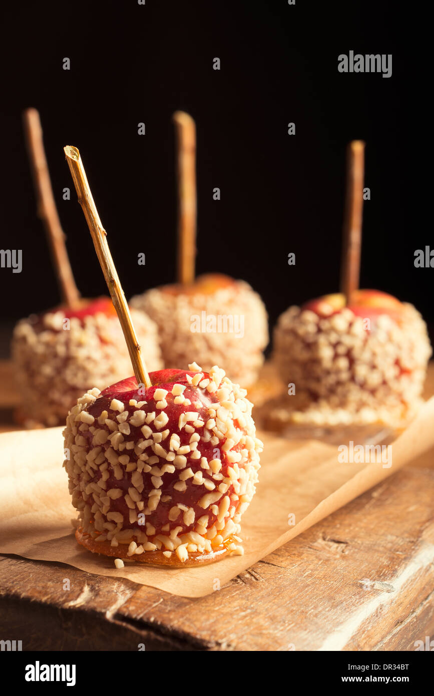 Toffee apples covered with chopped nuts Stock Photo