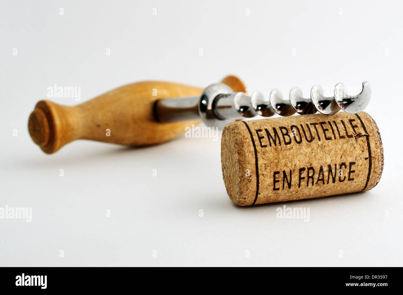 vintage old corkscrew and wine cork with inscription embouteille en France Stock Photo