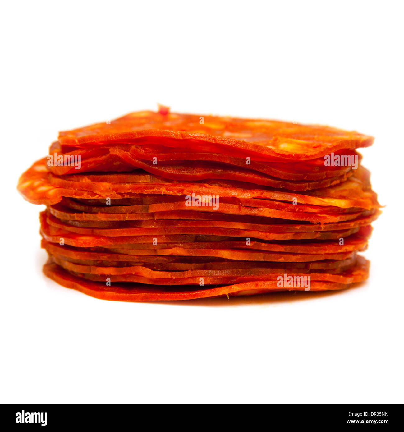 Sliced Spanish chorizo sausage isolated on a white studio background. Stock Photo