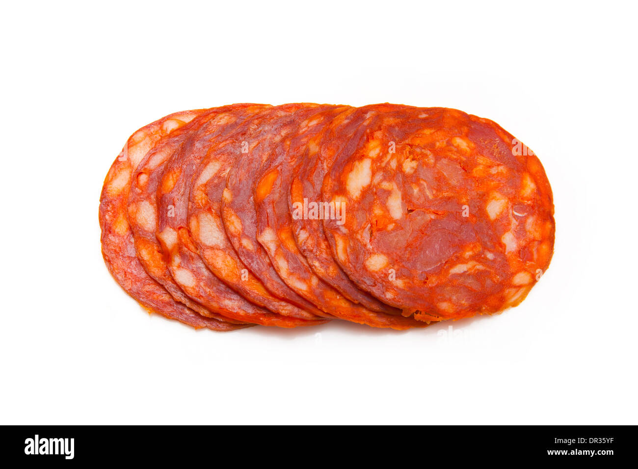 Sliced Spanish chorizo sausage isolated on a white studio background. Stock Photo