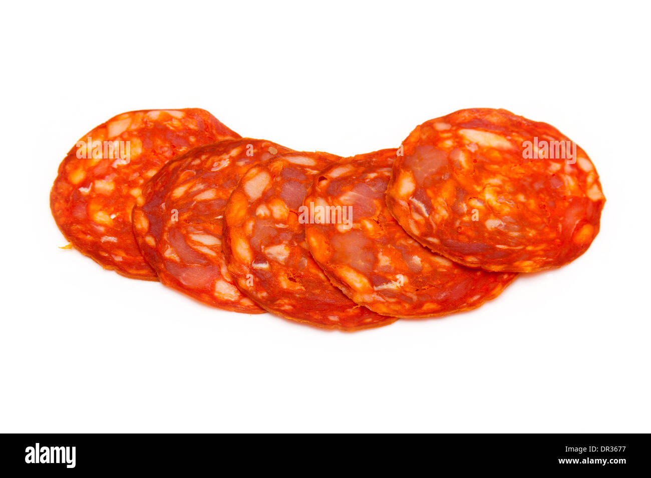 Sliced Spanish chorizo sausage isolated on a white studio background. Stock Photo