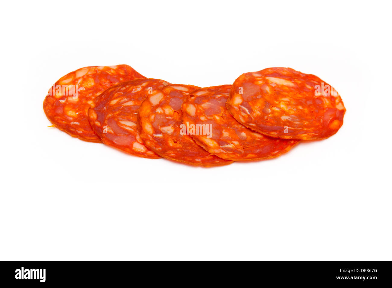 Sliced Spanish chorizo sausage isolated on a white studio background. Stock Photo