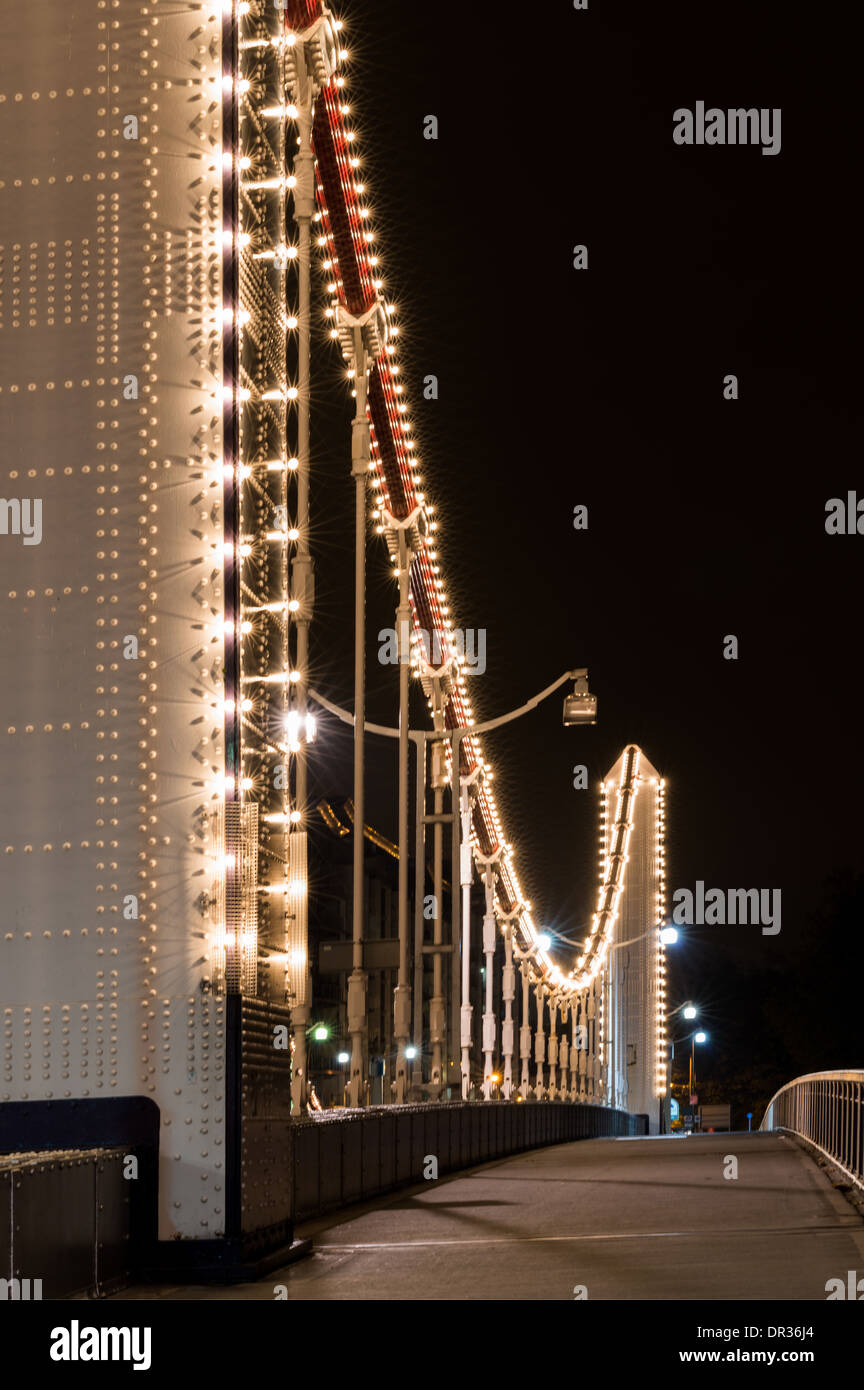 Chelsea Bridge, West London, a road traffic bridge spanning the River Thames, at night, lit up Stock Photo