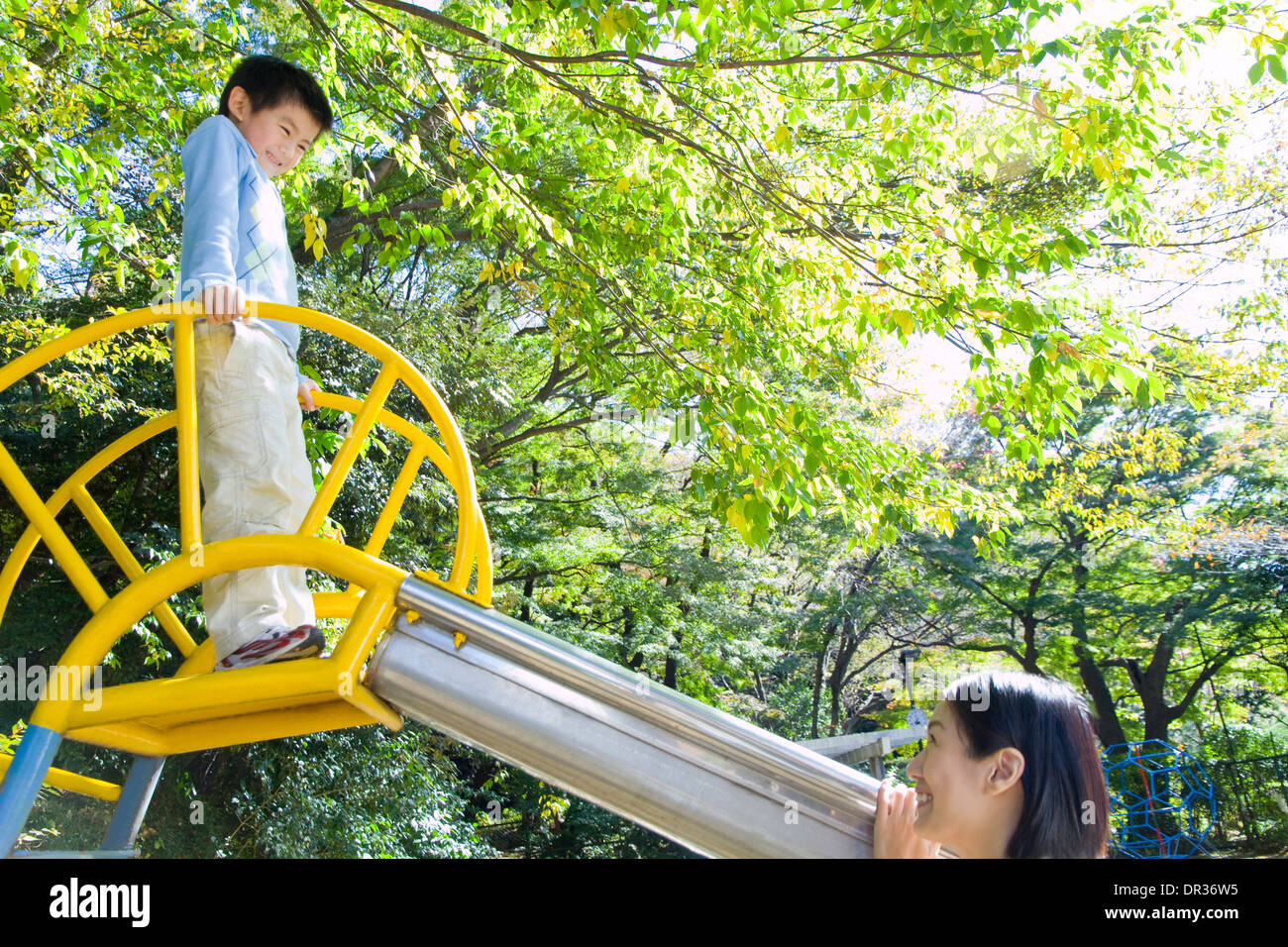 Mother and son playing in playground Stock Photo - Alamy