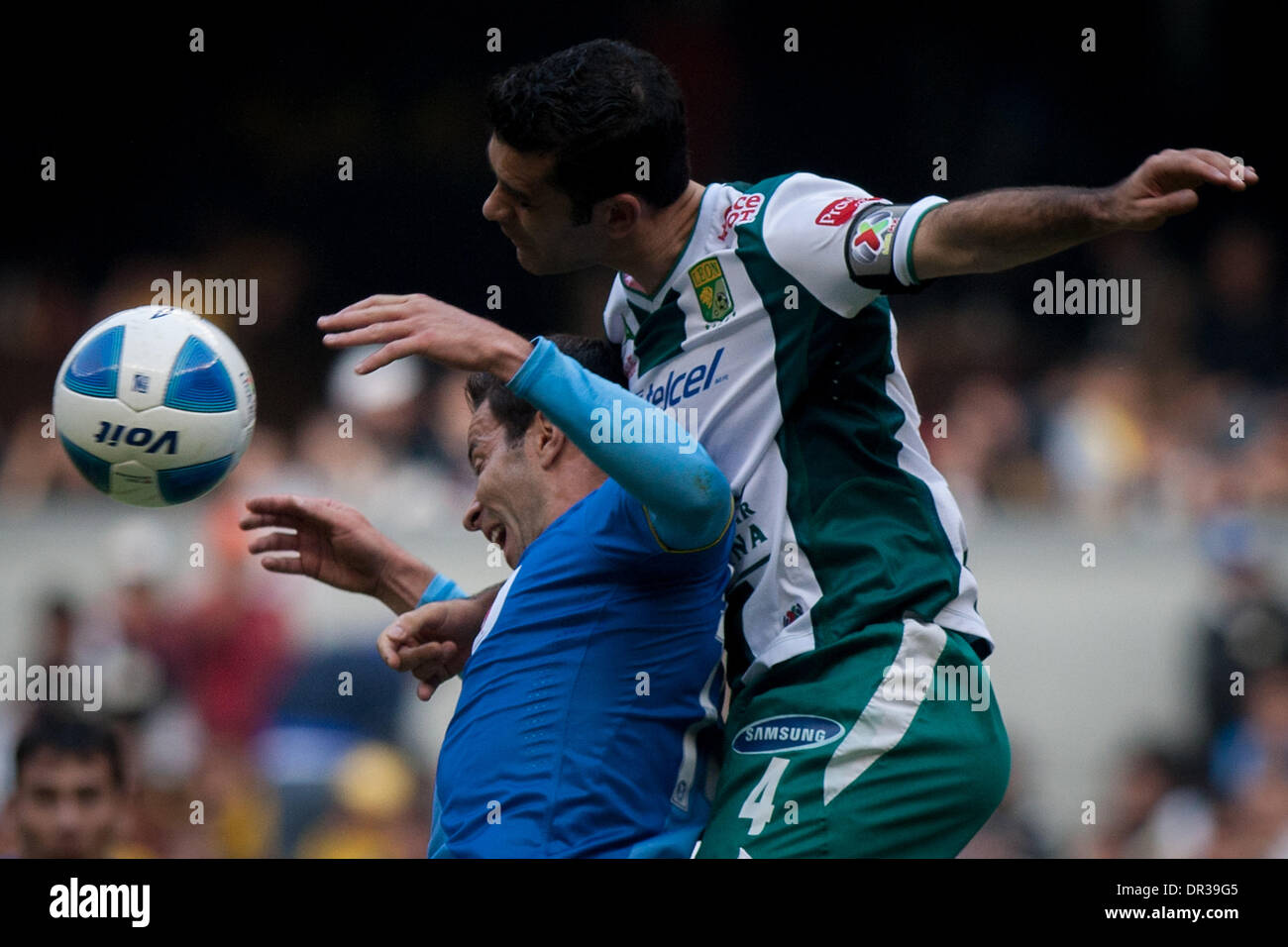 Mexico City, Mexico. 19th Jan, 2014. America's Luis Gabriel Rey (L) vies for the ball with Leon's Rafael Marquez during their match of the MX League Closing Tournament 2014, in Mexico City, capital of Mexico, on Jan. 18, 2014. Credit:  Pedro Mera/Xinhua/Alamy Live News Stock Photo