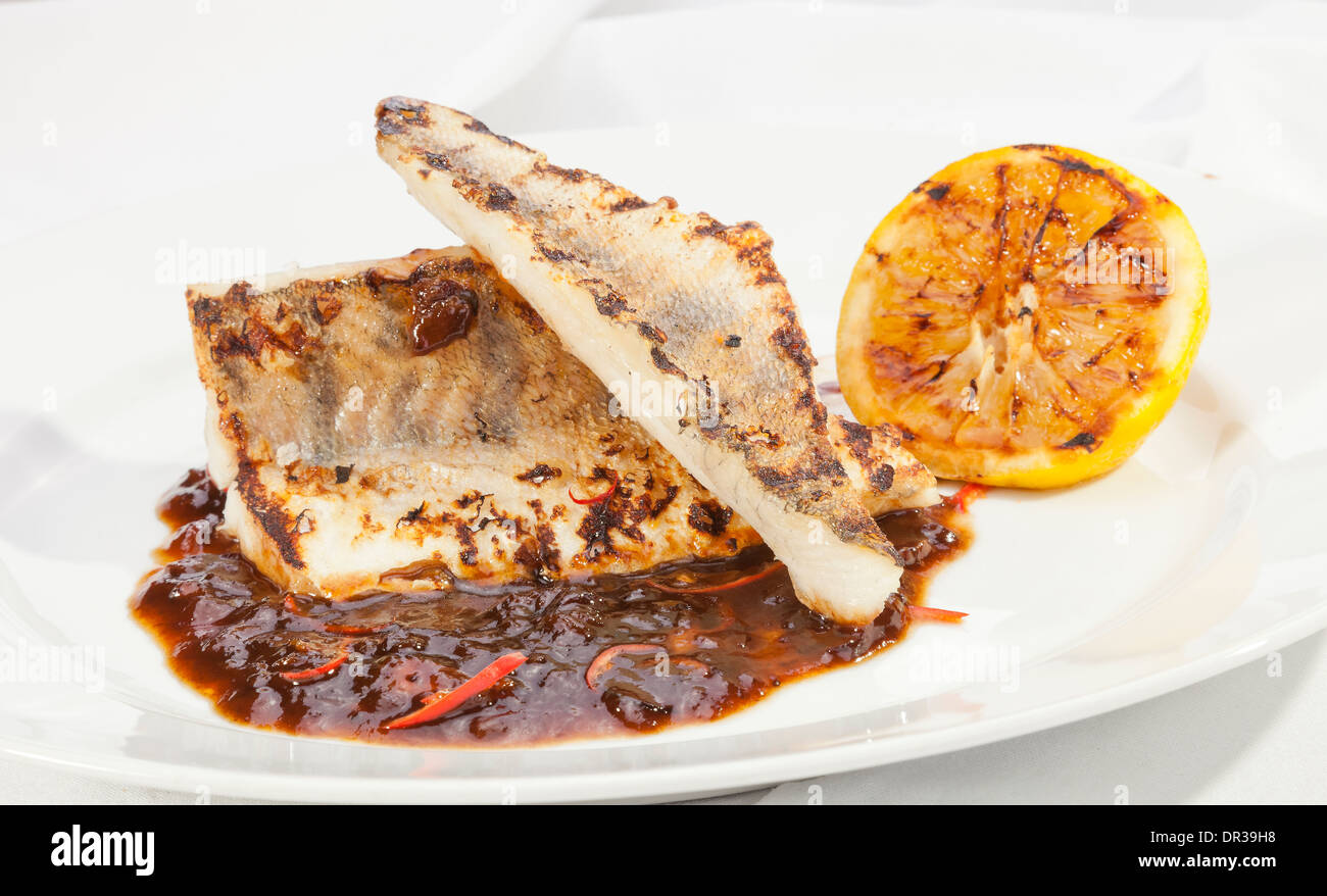 Grilled Pike perch with lemon and spicy sauce Stock Photo