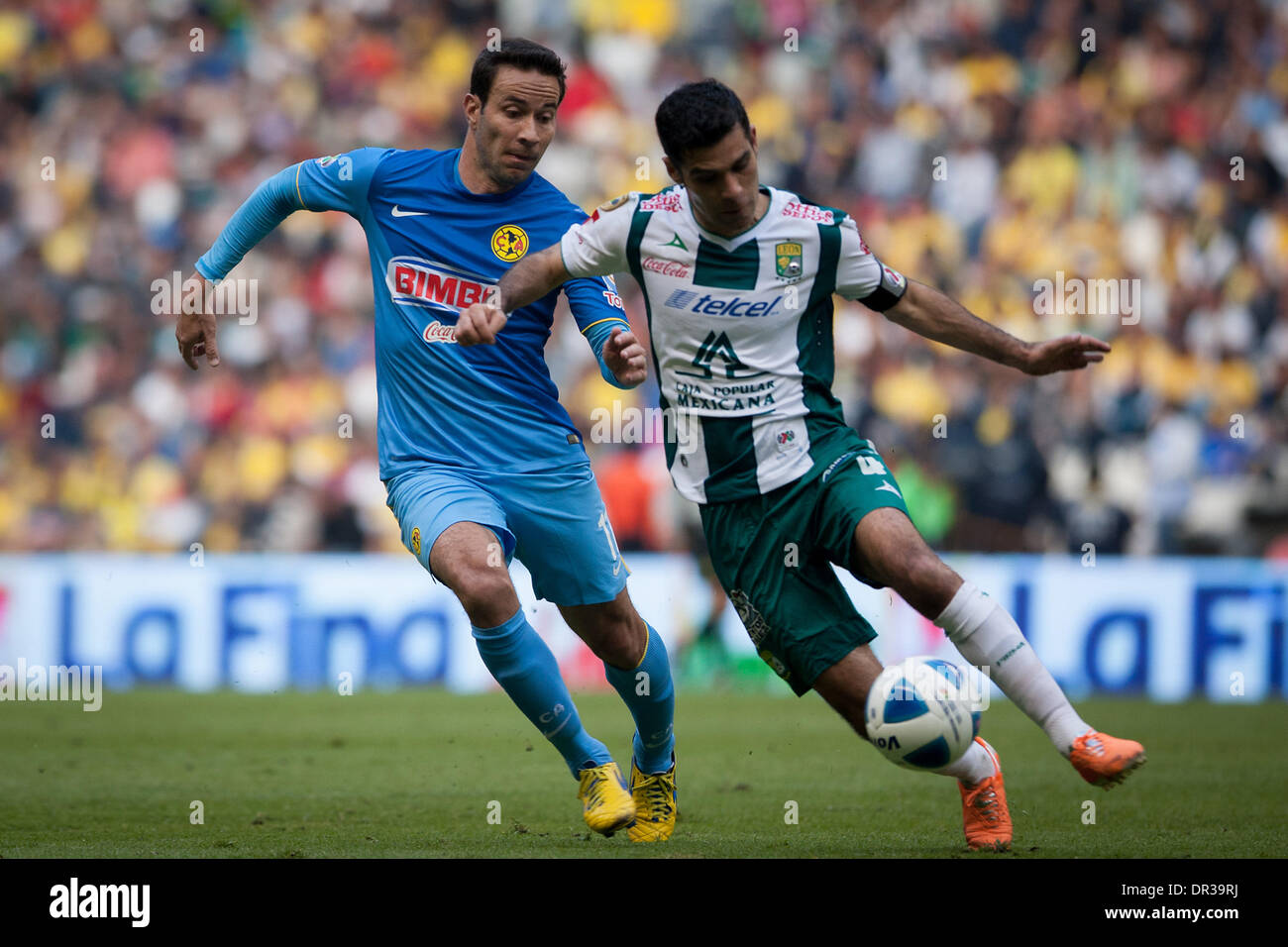 Mexico City, Mexico. 19th Jan, 2014. America's Luis Gabriel Rey (L) vies for the ball with Leon's Rafael Marquez during their match of the MX League Closing Tournament 2014, in Mexico City, capital of Mexico, on Jan. 18, 2014. Credit:  Pedro Mera/Xinhua/Alamy Live News Stock Photo