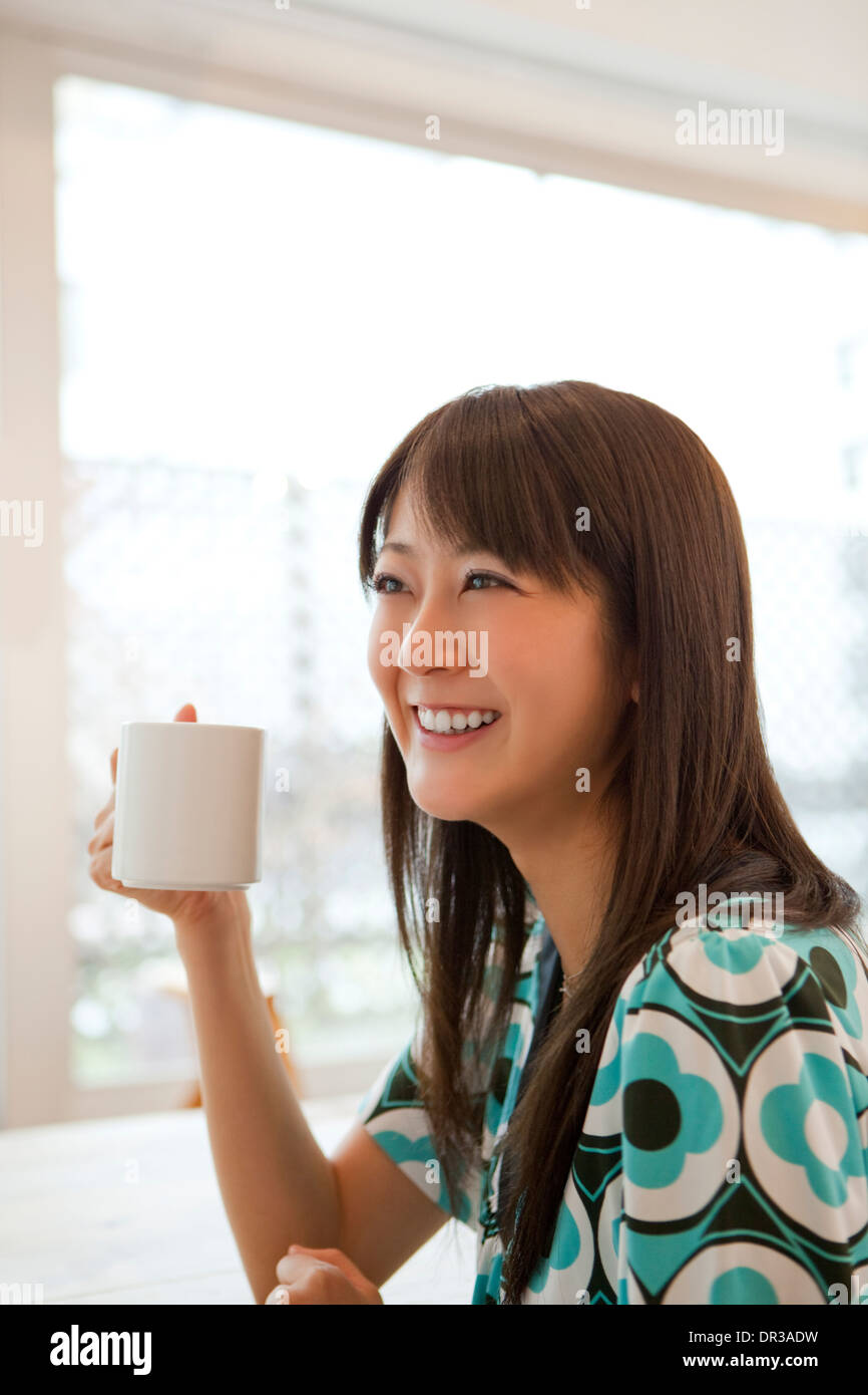 Young woman having hot drink Stock Photo