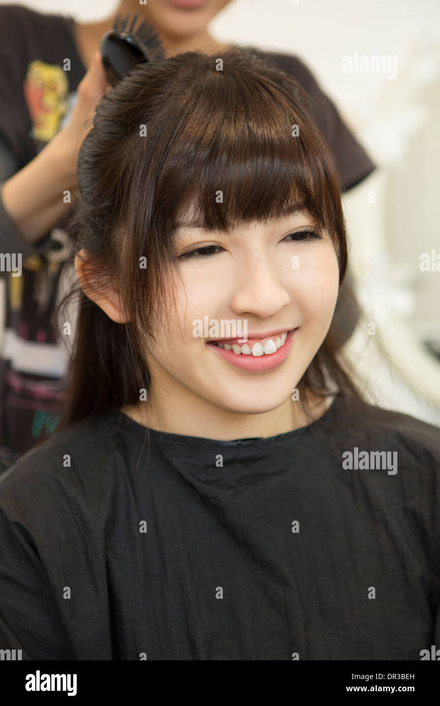 Young woman getting her hair set Stock Photo