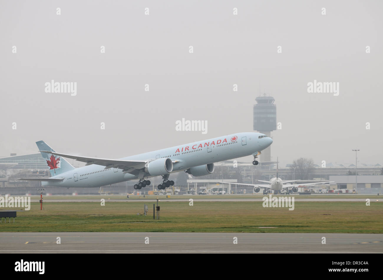 Air Canada Boeing 777-300ER C-FNNU taking off in foggy weather conditions from Vancouver International Airport Canada Stock Photo