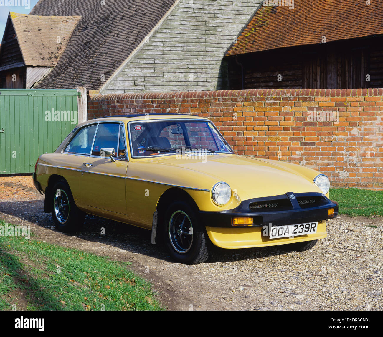 MG MGB GT 1976 - Rubber Bumper Model - in countryside cottage setting Stock Photo