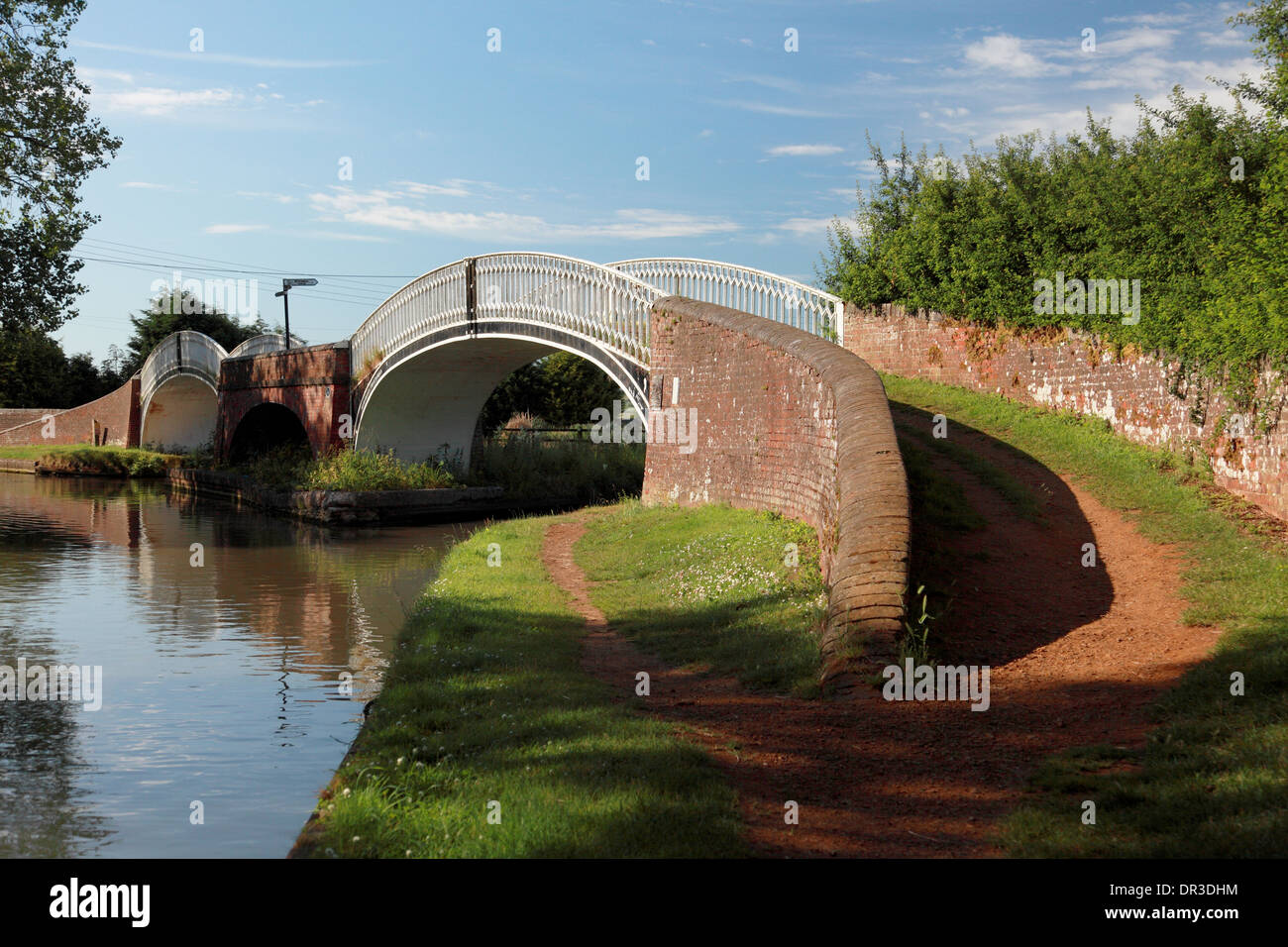 The elegant double iron bridges at Braunston Turn where the Oxford Canal on the right meets the Grand Union Canal on the far lef Stock Photo