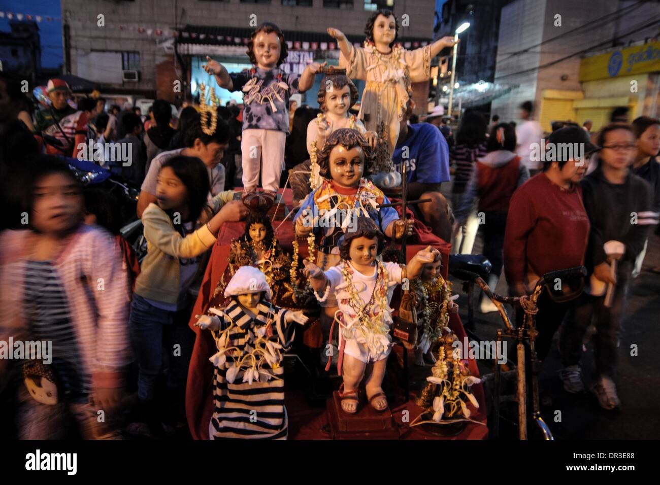 Manila, Philippines. 19th Jan, 2014. Santo Nino statues adorn a pedicab during the Feast of Santo Nino at a church in the poor district of Tondo in Manila, Philippines, January 19, 2014. The festival is celebrated every third Sunday of January which honors the Child Jesus more commonly known as ''Santo Nino'' to Filipino Catholics.Photo: Ezra Acayan/NurPhoto Credit:  Ezra Acayan/NurPhoto/ZUMAPRESS.com/Alamy Live News Stock Photo