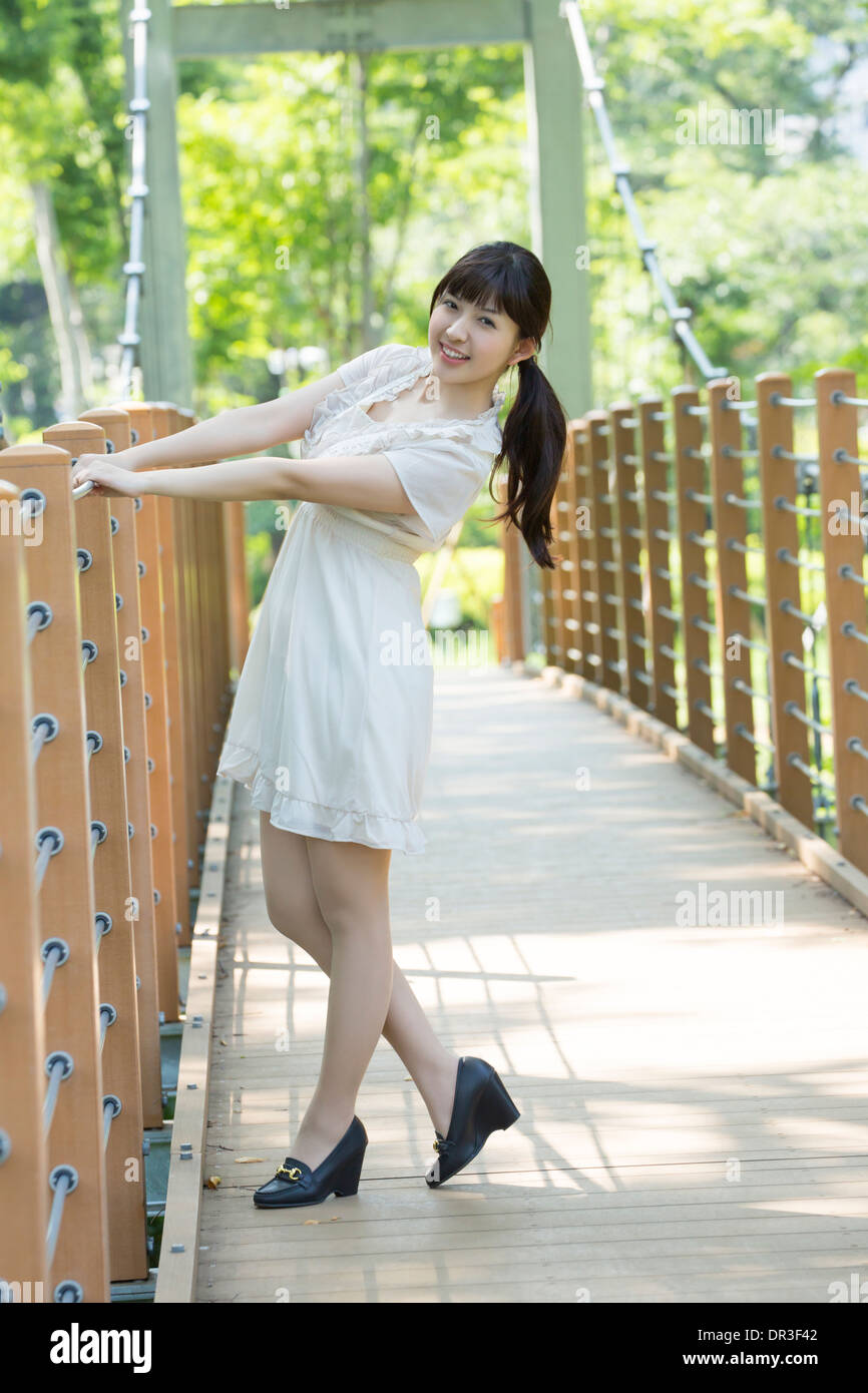 Young woman standing on bridge Stock Photo