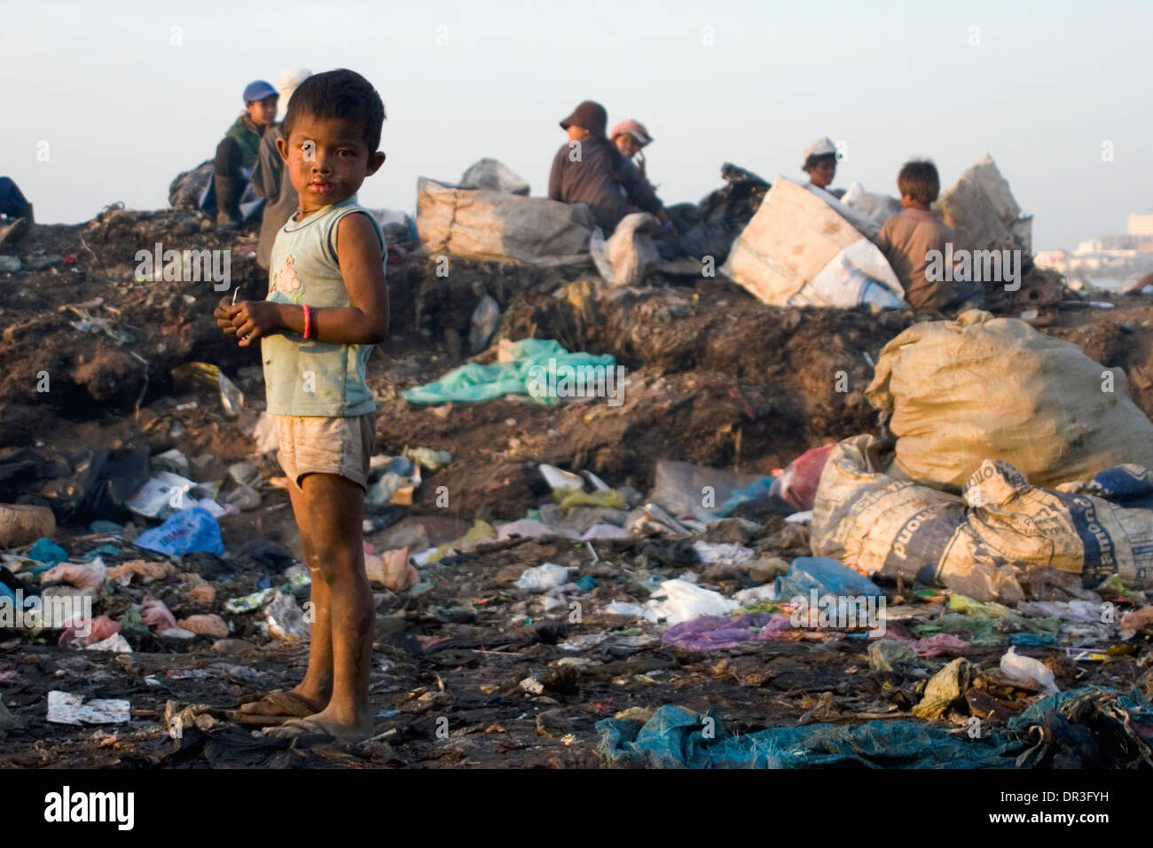 A Young Child Laborer Boy Is Standing In A Toxic Garbage At The Stung 