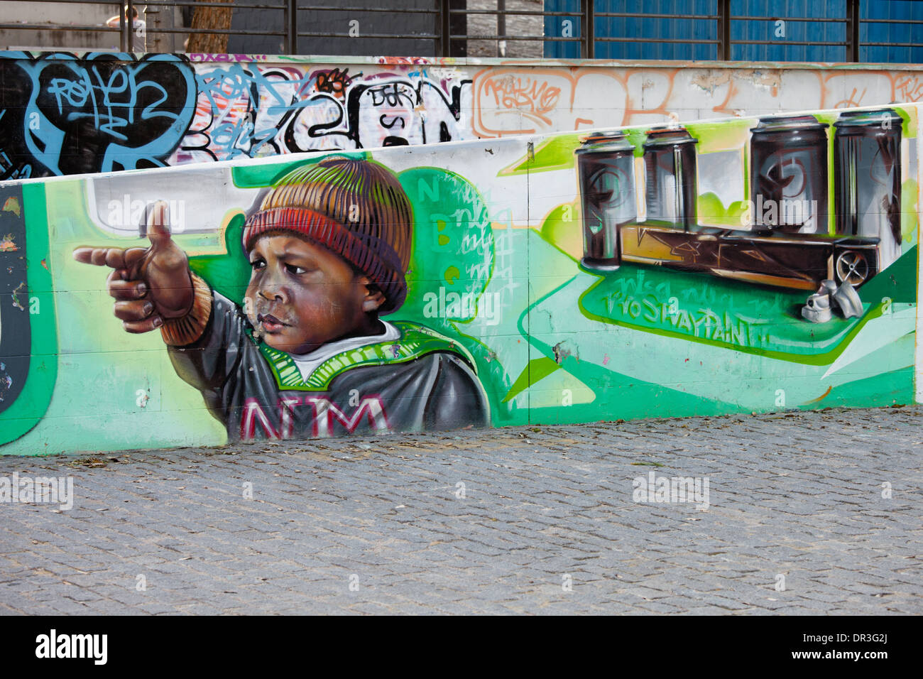 Black kid with finger gun hand gesture, mural in Seville, Spain. Stock Photo