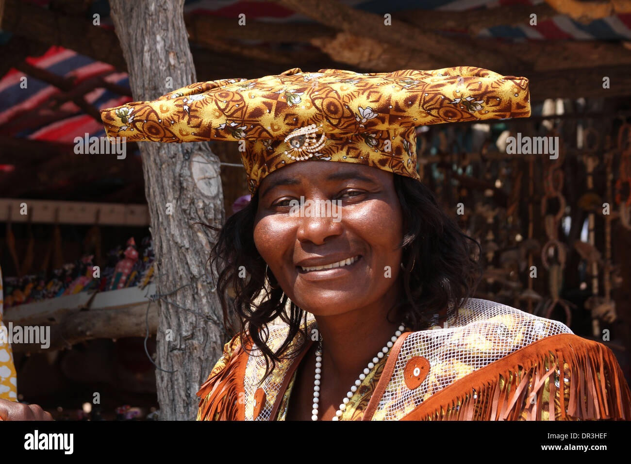 Herero tribal woman in her traditional Victorian dress ,wearing the typical 'horn hat',in Namibia.Africa. Stock Photo