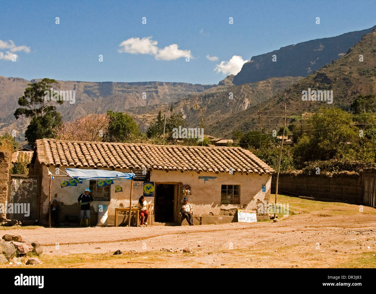 Roadside restaurant in village near Cusco Peru, simple adobe building by dirt road at foot of steep slopes of Andes Mountains Stock Photo
