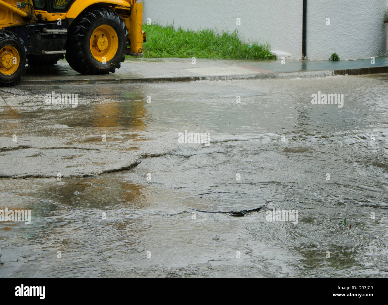 Street flooded after heavy rain storm, with truck in background. Spain. Stock Photo