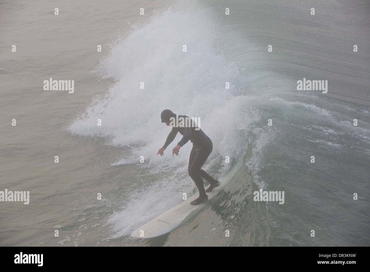 Surfing in the Mist At Hermosa Beach, Los Angeles, California. Stock Photo