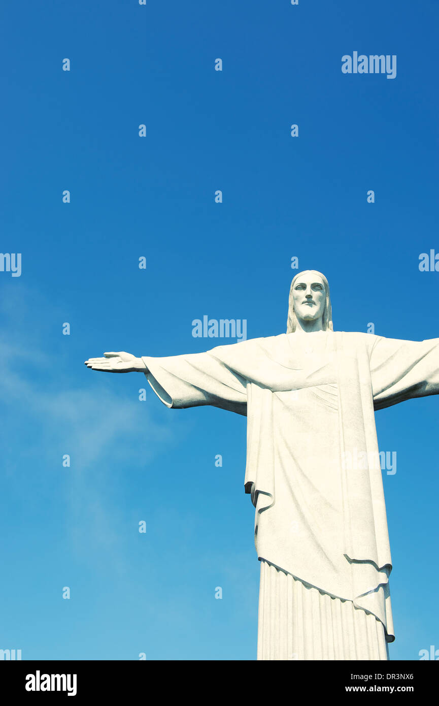 Corcovado Christ the Redeemer standing in bright blue sky in Rio de Janeiro Brazil vertical Stock Photo