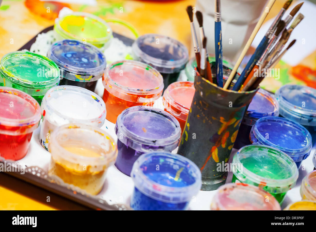 Colorful acrylic paints and brushes on the table Stock Photo