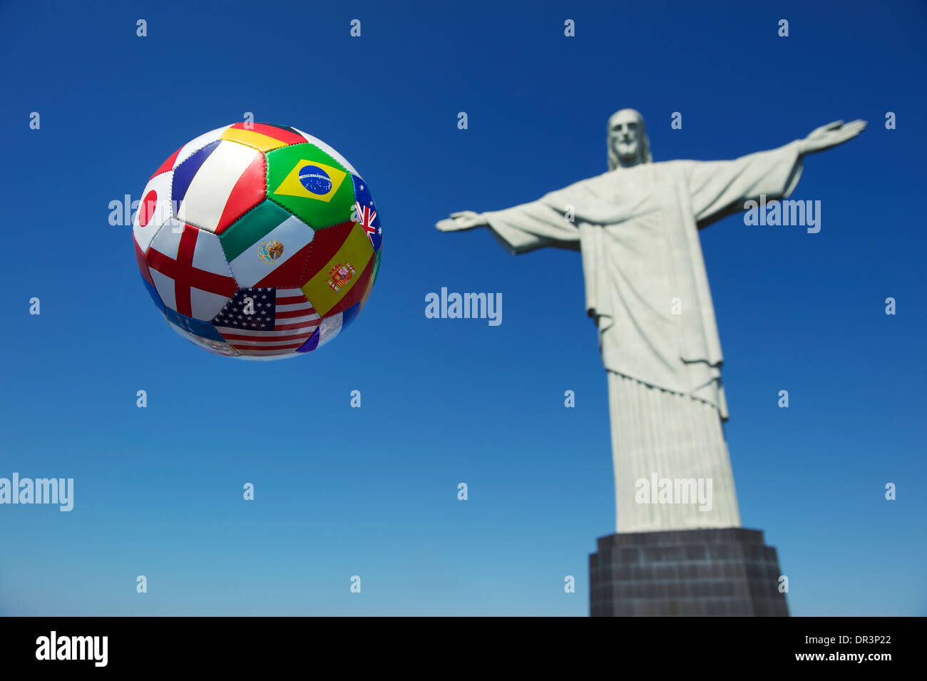 Brazil international flag football soccer ball in the air bright blue sky Corcovado Cristo Redentor Rio de Janeiro Stock Photo