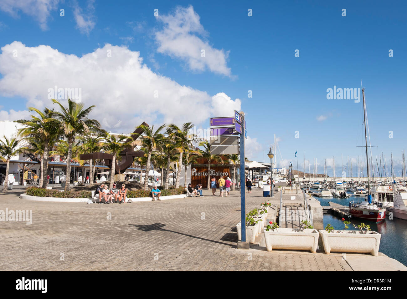 Seafront promenade around the marina in coastal holiday resort of Puerto Calero, Lanzarote, Canary Islands, Spain Stock Photo
