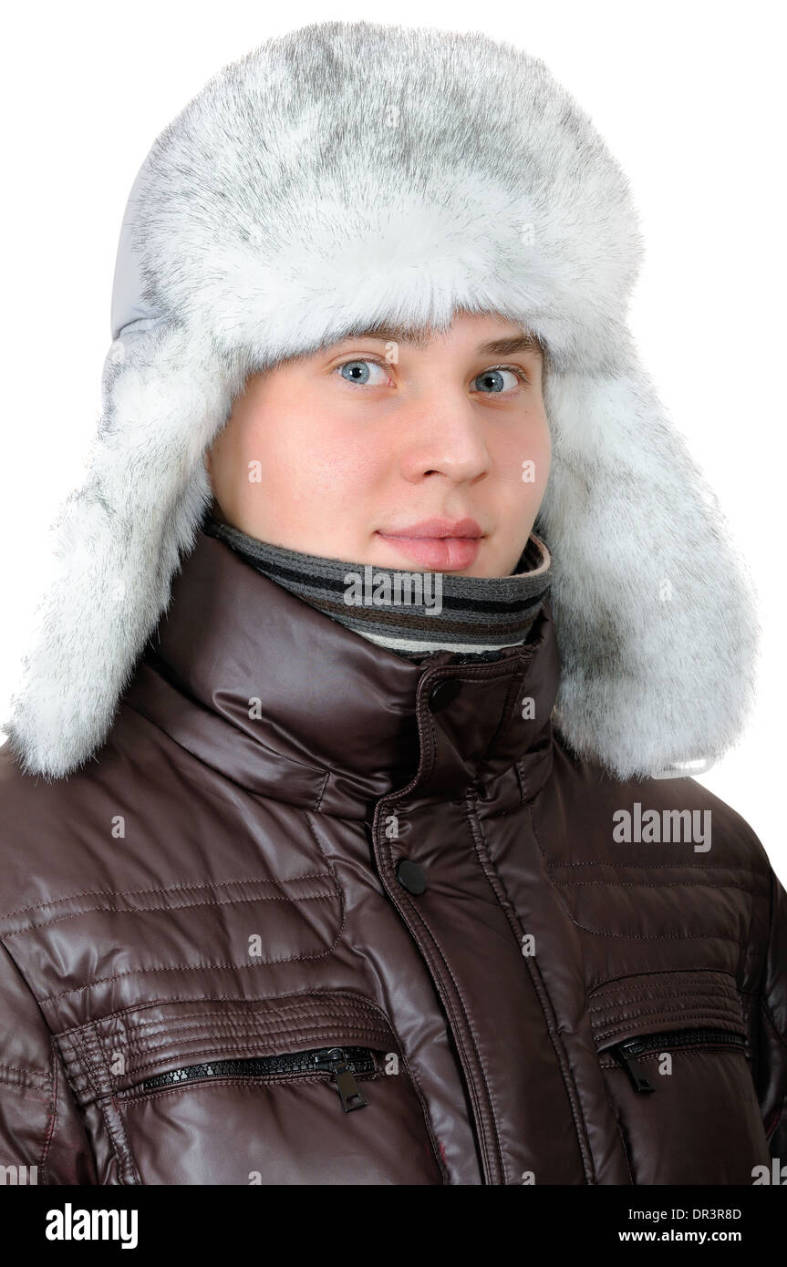 Portrait of teenage boy with blue eyes in winter hat with white fur Stock Photo