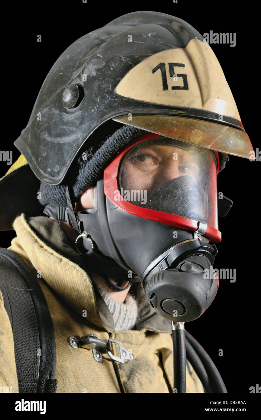 Portrait of a firefighter in breathing apparatus on a black background Stock Photo