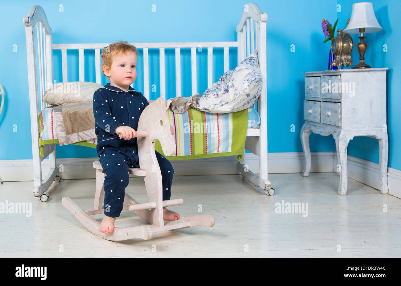 Child play with a wooden Rocking Toy horse pony. Stock Photo