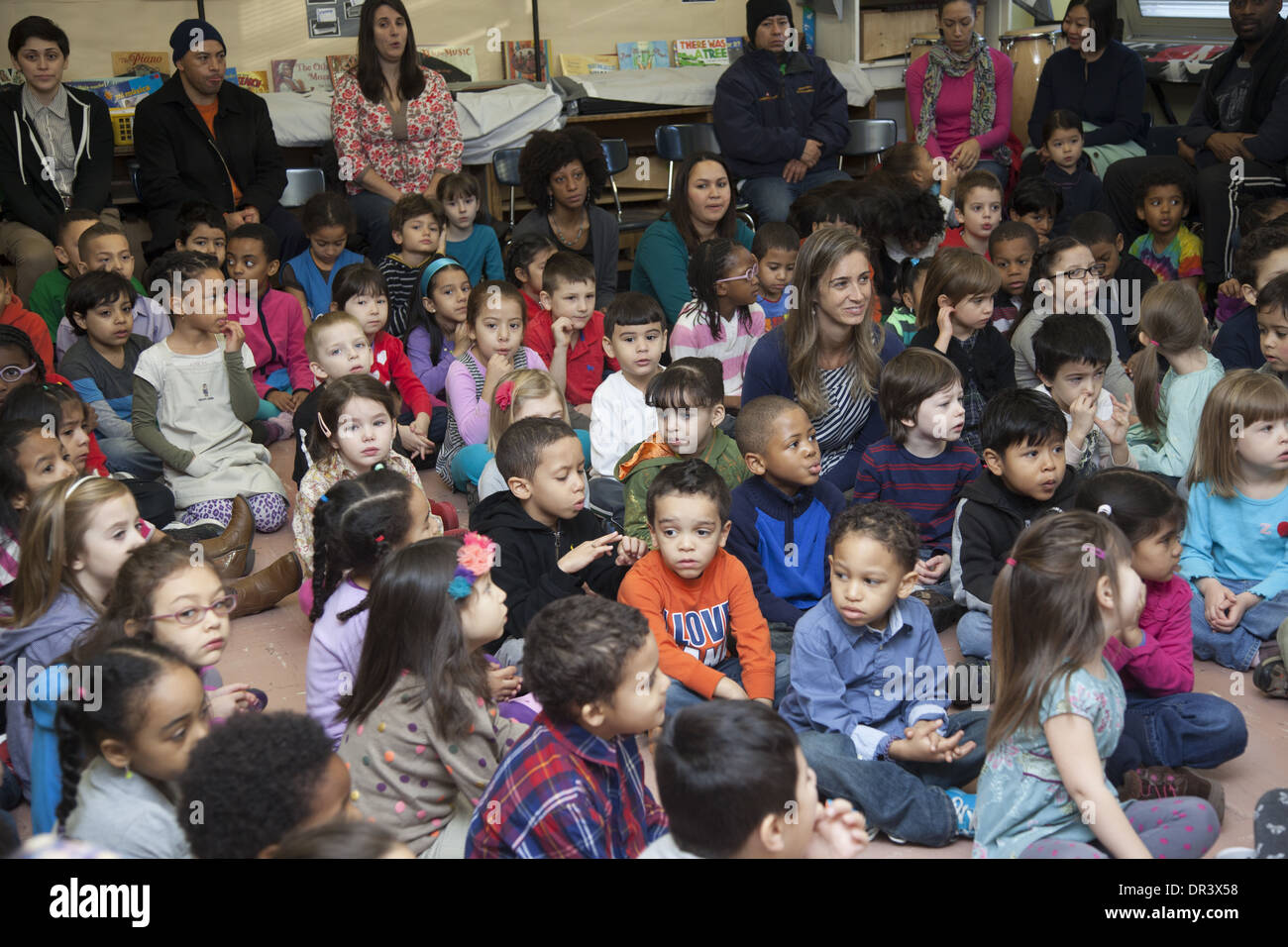 Children, teachers & parents sing together every Monday morning at the Castle Bridge Public Elementary School, Manhattan, NYC Stock Photo