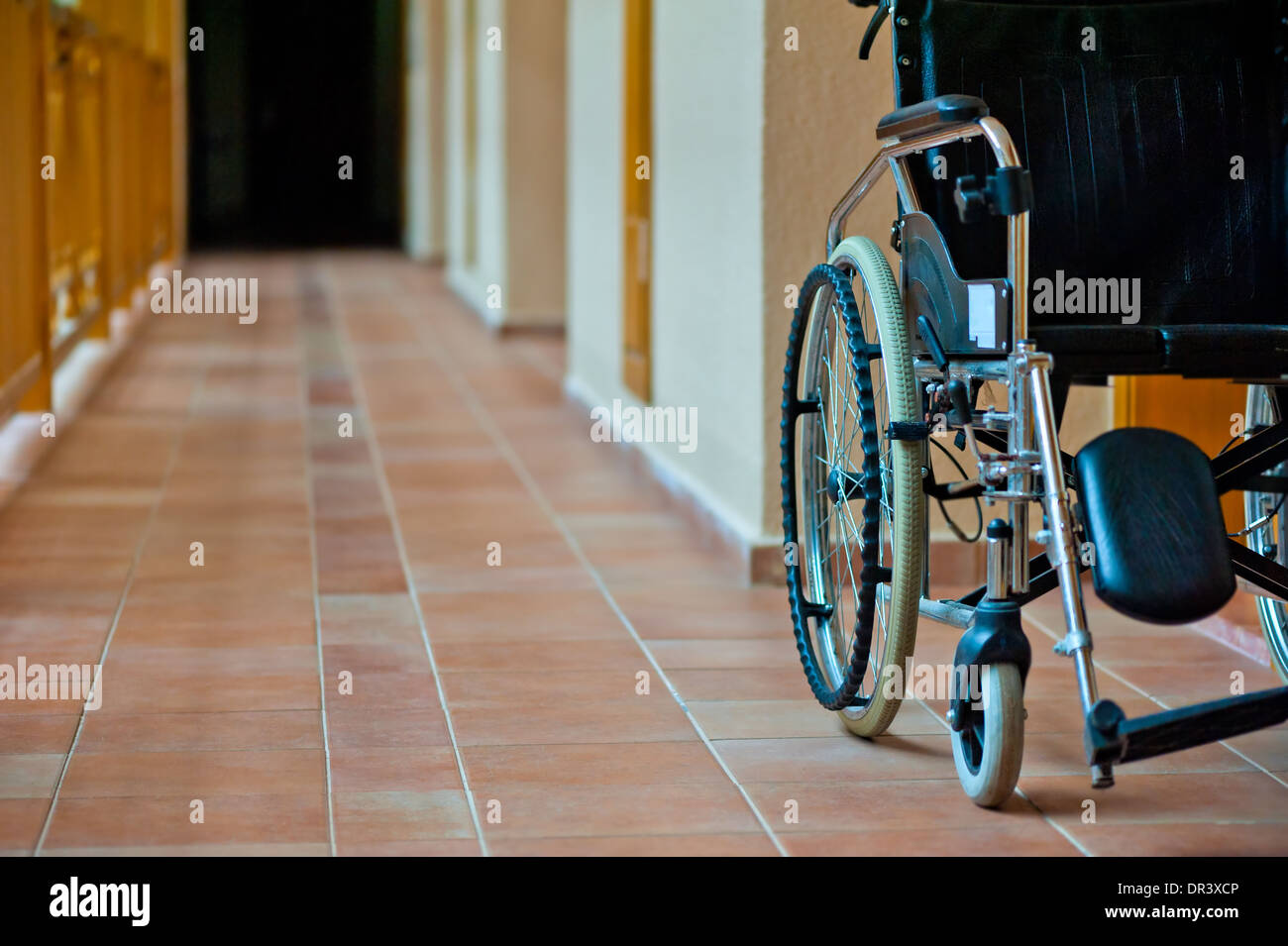 empty wheelchair in hospital corridor Stock Photo